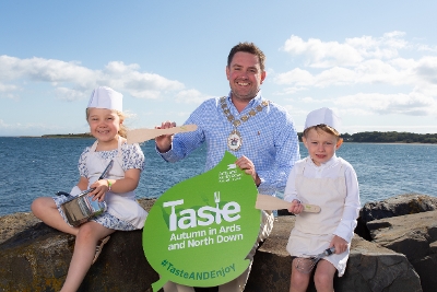 Mayor of Ards and North Down, Councillor Craig Blaney, alongside Lily and Elliot, helping launch Taste Autumn 2026, a celebration of local food and drink, 11-27 September.